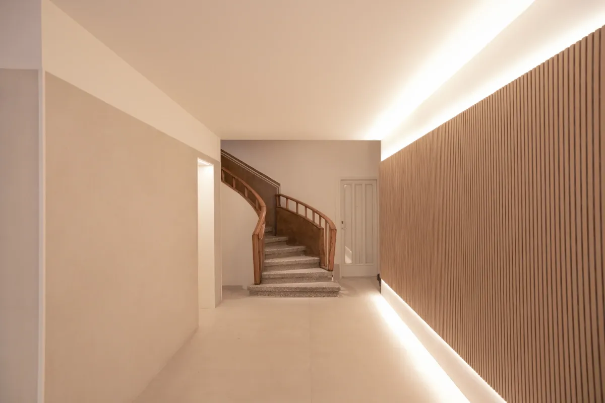 vestíbulo edificio en L'Eixample-Pared-lamas-de-madera-escalera-madera